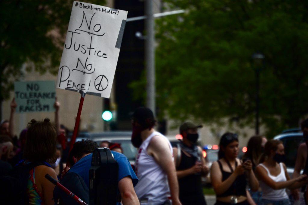 "No Justice, No Peace," reads the sign. Photo by Maddy Day.
