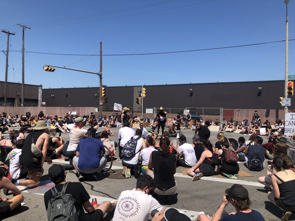 Group of protesters sitting at Mitchell Street. Photo by Jeramey Jannene.