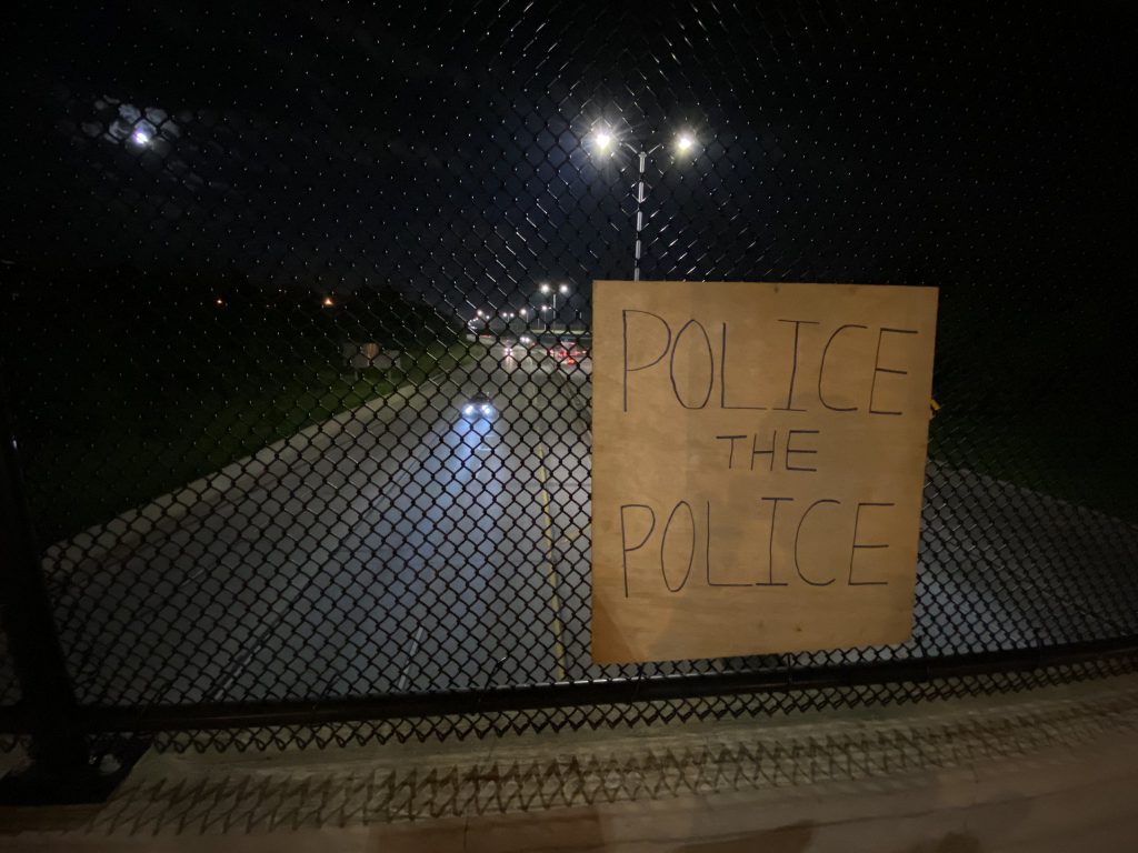 "Police the Police" sign attached to an overpass. Photo by Graham Kilmer.