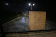 "Police the Police" sign attached to an overpass. Photo by Graham Kilmer.
