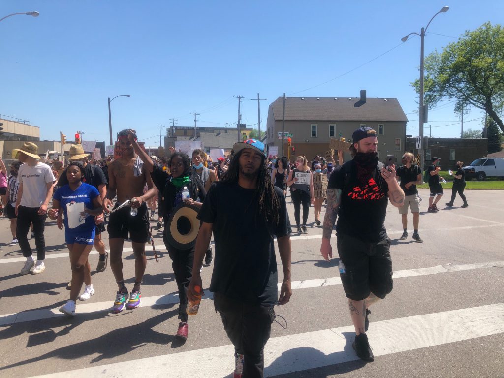 Frank Nitty leads a march north through Walker's Point. Photo by Jeramey Jannene.