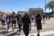 Frank Nitty leads a march north through Walker's Point. Photo by Jeramey Jannene.