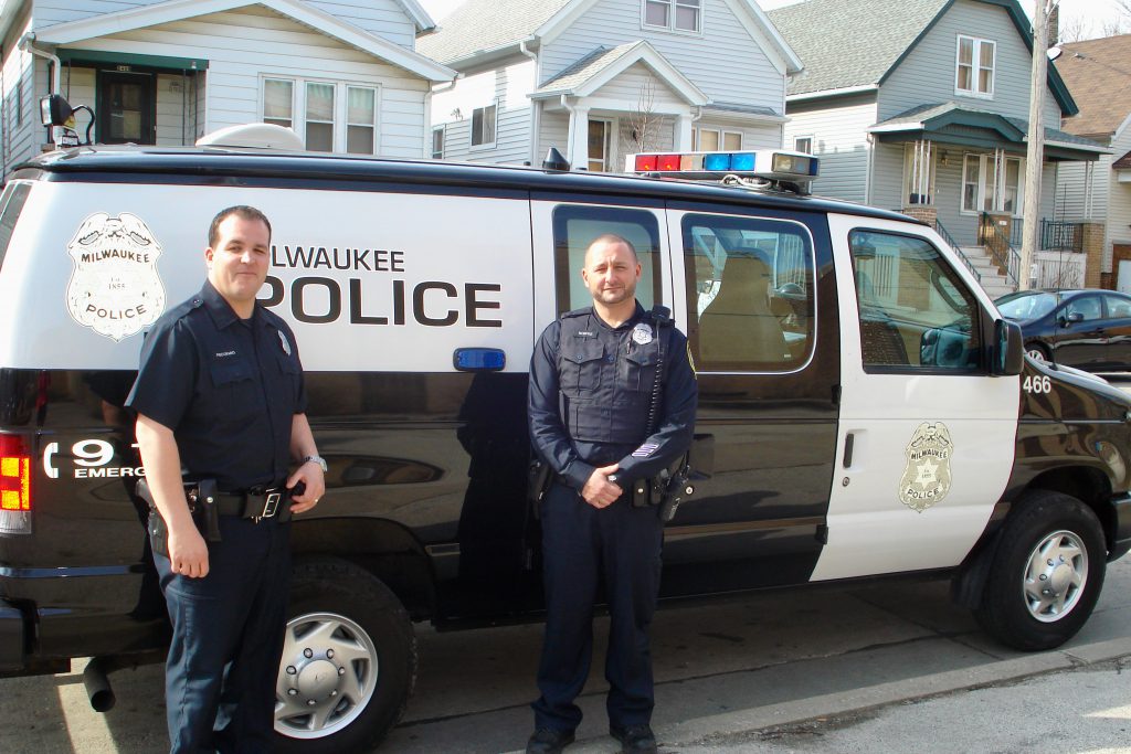 Under a state-mandated contract, MPD officers comb the streets for truants and shuttle them to a center where an MPS social worker evaluates their needs. MPD officers Shane Pecoraro and Ray Monfre are shown on the job in 2014. File photo by Kelly Meyerhofer/NNS.