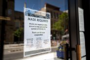 A sign hangs on the door of a business in downtown Madison on Wednesday, July 22, 2020. Angela Major/WPR.