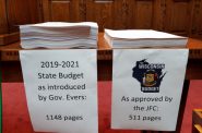 Republicans stacked a paper copy of Gov. Tony Evers' budget bill next to their own on the day the Wisconsin Assembly passed its version of a two-year spending plan. The GOP budget bill is the shortest in decades. Shawn Johnson/WPR