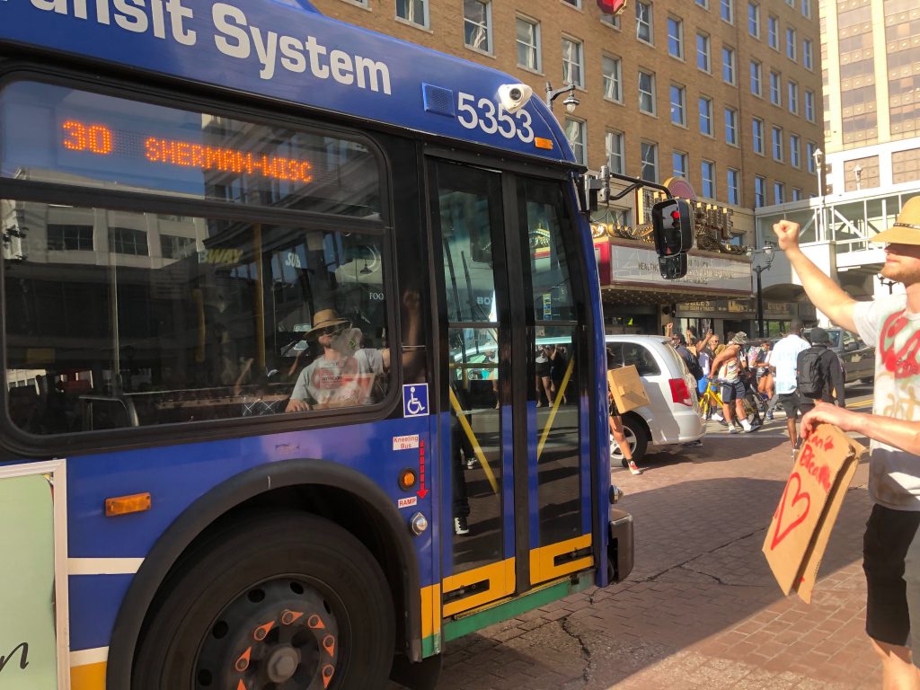 A Milwaukee County Transit System (MCTS) bus makes it way past a protest march on June 6th. Photo by Jeramey Jannene.