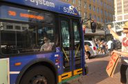 A Milwaukee County Transit System (MCTS) bus makes it way past a protest march on June 6th. Photo by Jeramey Jannene.