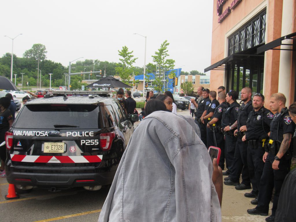Wauwatosa officers form a line in front of Mayfair Mall’s Cheesecake Factory. A few protesters had just been arrested. Photo by Isiah Holmes/Wisconsin Examiner.
