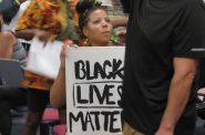 A Black Lives Matter protester attending a Wauwatosa City Council meeting. Protesters had been marching to get officer Joseph Mensah fired for killing three people in five years. Photo by Isiah Holmes/Wisconsin Examiner.