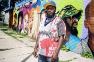 Khalil Coleman stands in front of a mural Thursday, Jul 30, 2020, in Milwaukee. Angela Major/WPR