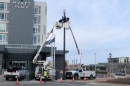 A crew installs 5G cellular equipment atop a utility pole in the Brewery District in April 2020. Photo by Jeramey Jannene.