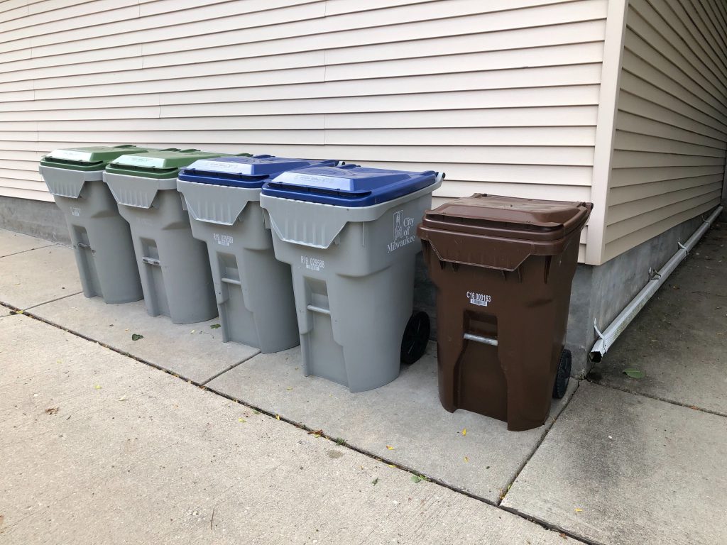 A compost bin (right) sits alongside Milwaukee trash and recycling bins. Photo by Jeramey Jannene.