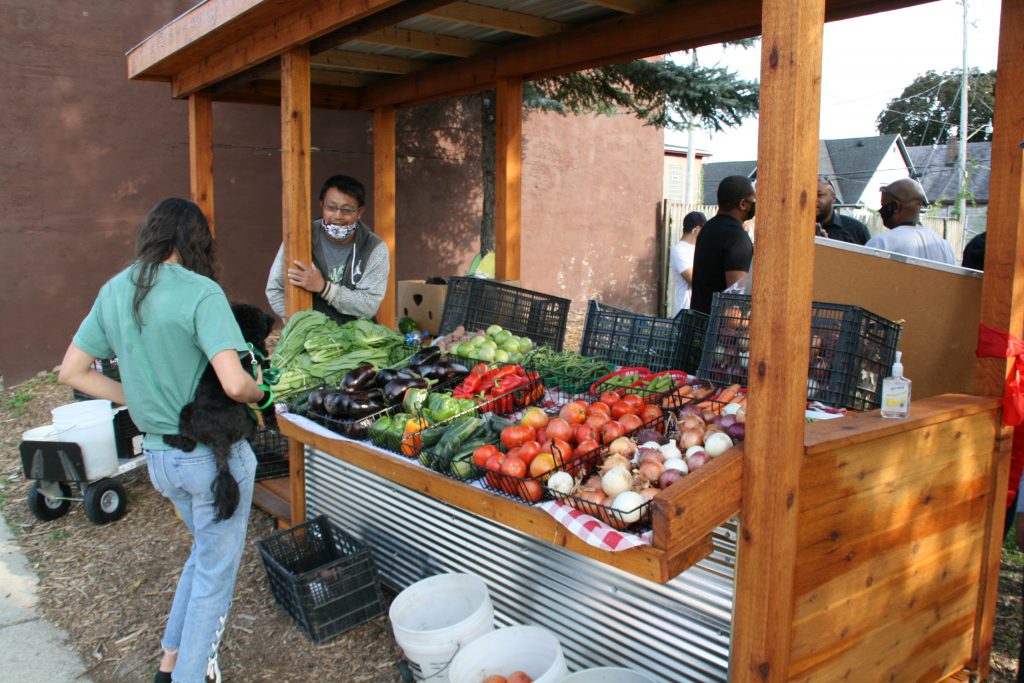 Vang Lee sells produce at the Vliet Street Oasis. Photo by Jeramey Jannene.