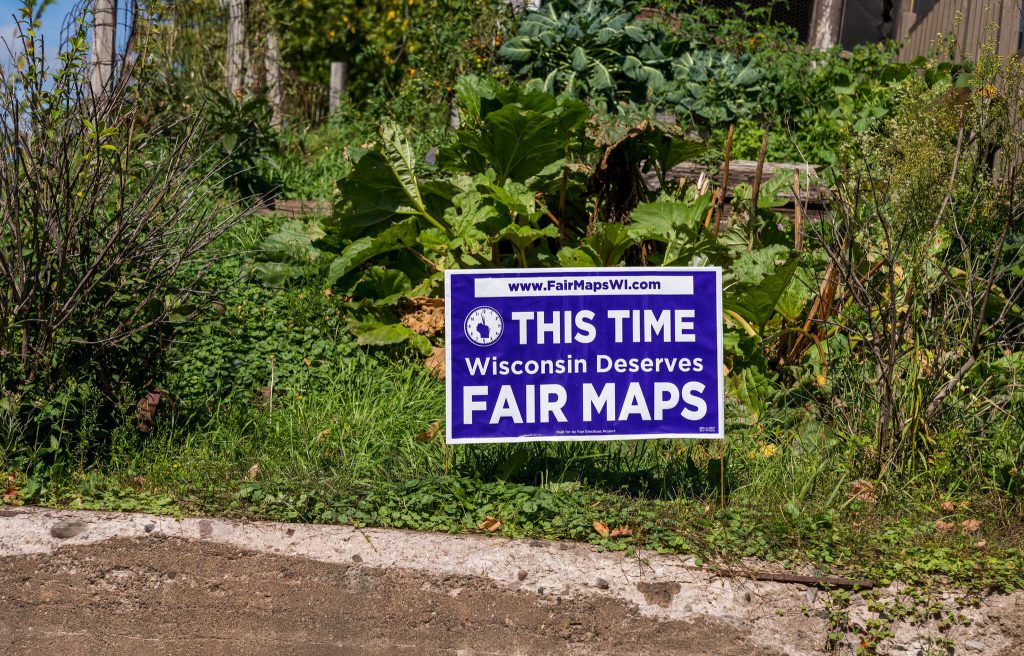 A yard sign in Mellen, Wisconsin reads: "This Time Wisconsin Deserves Fair Maps," paid for by the Fair Elections Project, FairMapsWI.com. The political sign supports redistricting legislation to reform gerrymandering. Wisconsin Fair Maps Coalition by Tony Webster (CC BY 2.0) https://creativecommons.org/licenses/by/2.0/
