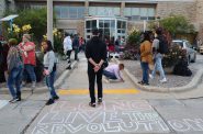 Protesters with The People's Revolution stand outside Wauwatosa City Hall. The words "long live the revolution" was chalked on the ground. Photo by Isiah Holmes/Wisconsin Examiner.