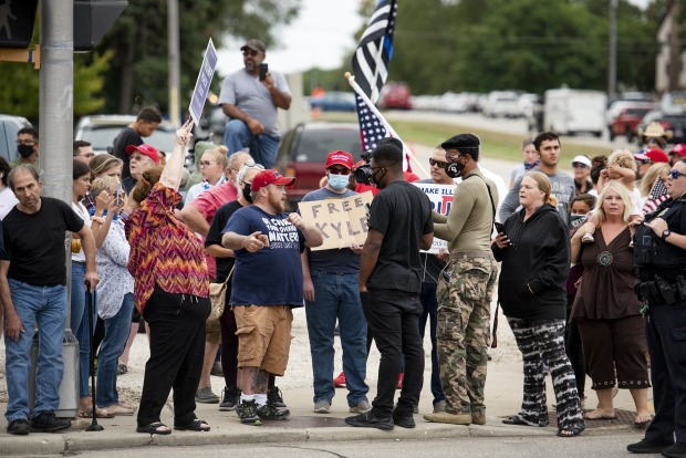 Trump supporters talk with protesters. Photo by Angela Blake/WPR