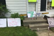 Demonstrators left signs calling for justice for Joel Acevedo outside Milwaukee Police officer Michael Mattioli's house in a protest on May 29, 2020. Madeline Fox/WPR