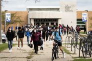 Students exit out of the front doors of Janesville Craig High School on Monday, Sept. 14, 2020, in Janesville. Face-to-face instruction is suspended at the school until at least Friday, Sept. 25, due to COVID-19 concerns. Angela Major/WPR