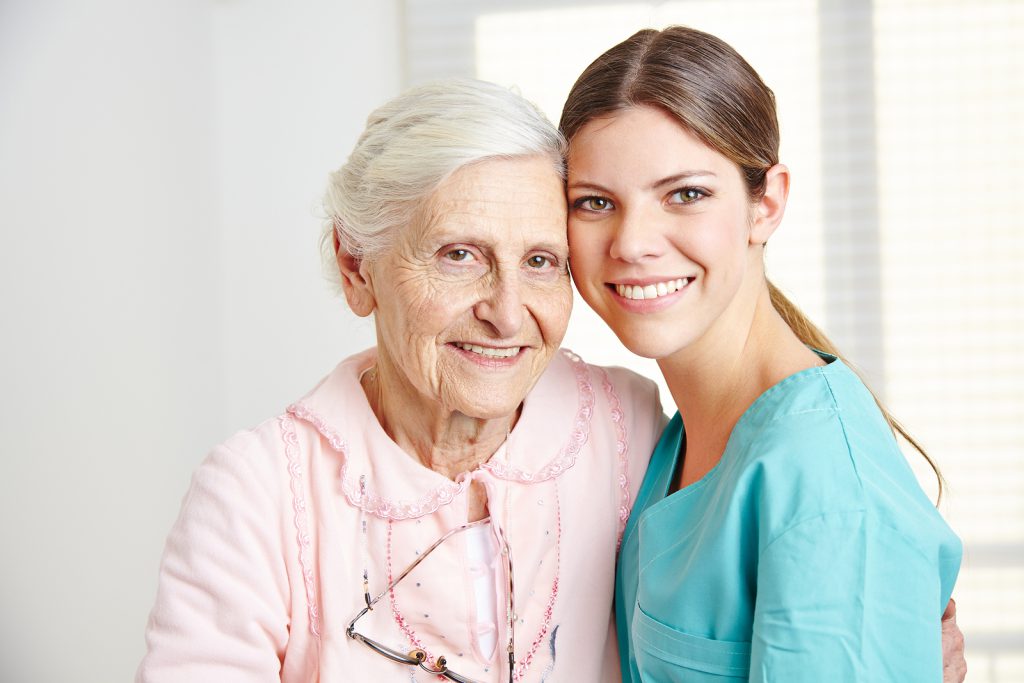 Caregiver with a senior woman in a nursing home. (Public Domain)