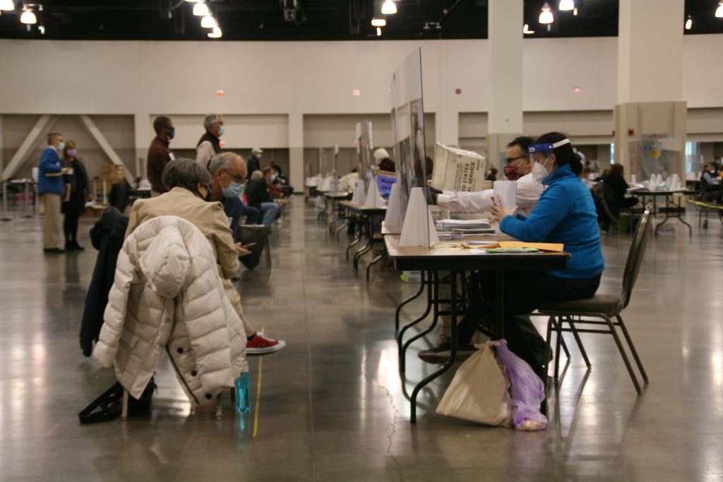 Observers watch workers at Milwaukee County's presidential recount. Photo by Jeramey Jannene.