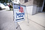 A sign at an in-person early voting location explains how to access curbside voting on Monday, July 27, 2020, in Janesville, Wis. Angela Major/WPR