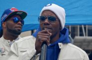 Nate Hamilton (right) exhorts the crowd to love one another and help build a peaceful community in 2016 as brother Dameion Perkins looks on. File photo by Andrea Waxman/NNS.