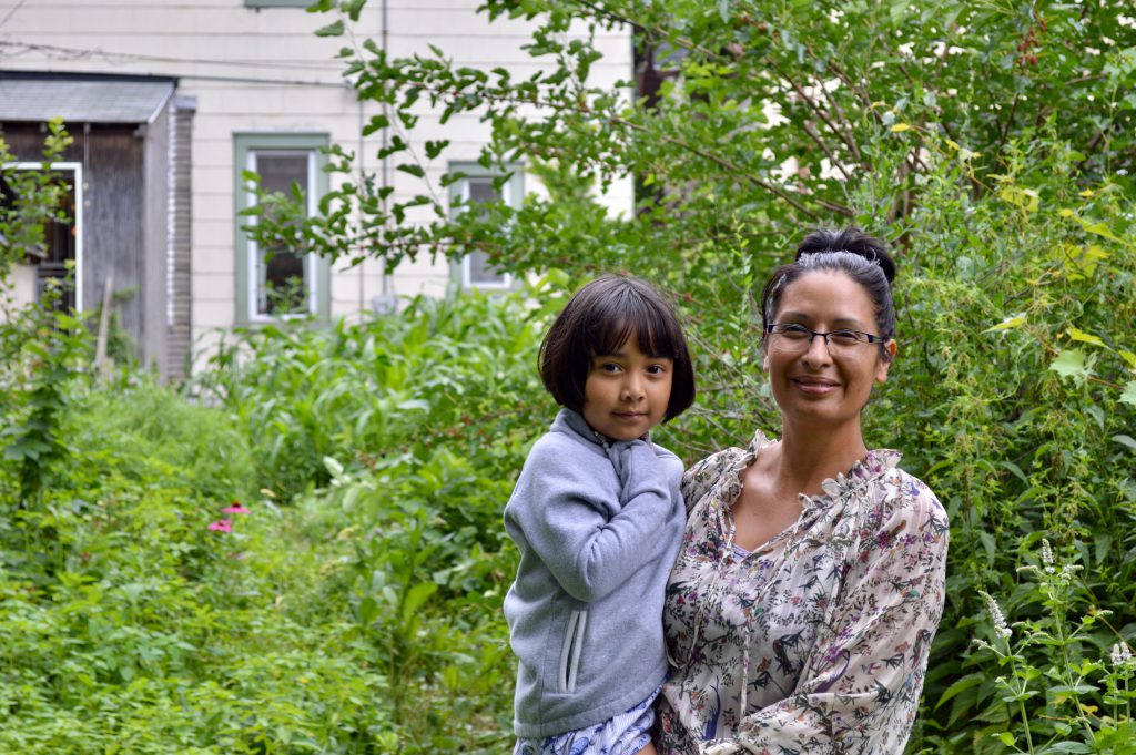 Like her mother before her, Angela Kingsawan has her daughters, including the youngest Elena (pictured here), work alongside her in the garden. Photo by Ana Martinez-Ortiz/NNS.