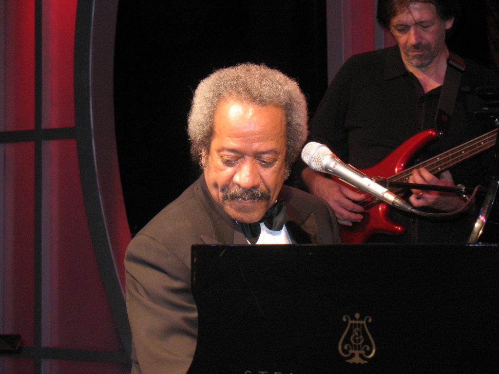 Allen Toussaint at the piano on stage at the Roosevelt Hotel, New Orleans October 24th, 2009. Photo by Marie Carianna, CC BY-SA 2.0 , via Wikimedia Commons