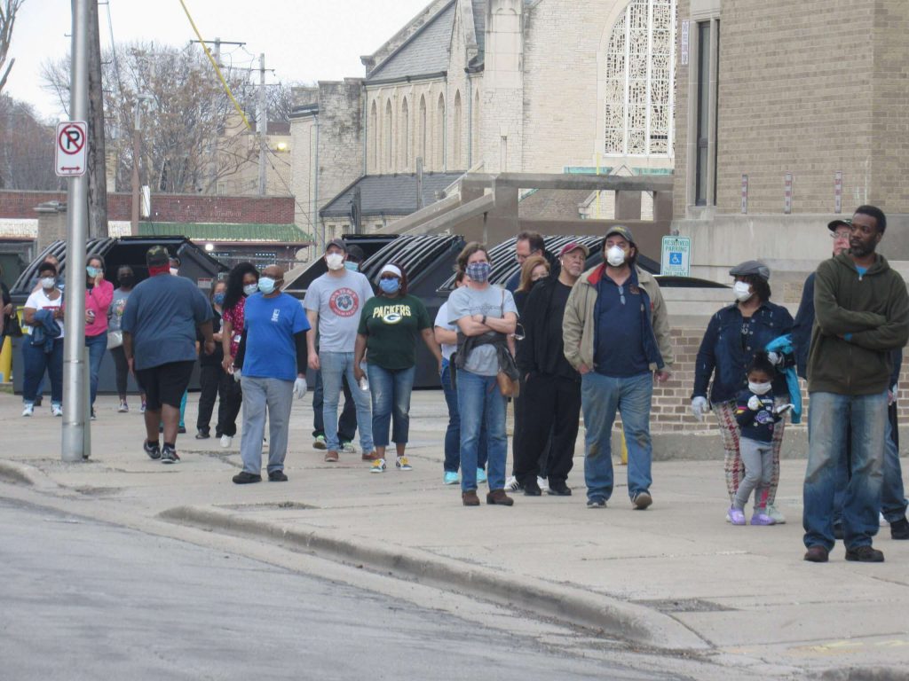 Voters wait in line to vote at Washington High School on April 7. Photo by Isiah Holmes/Wisconsin Examiner.