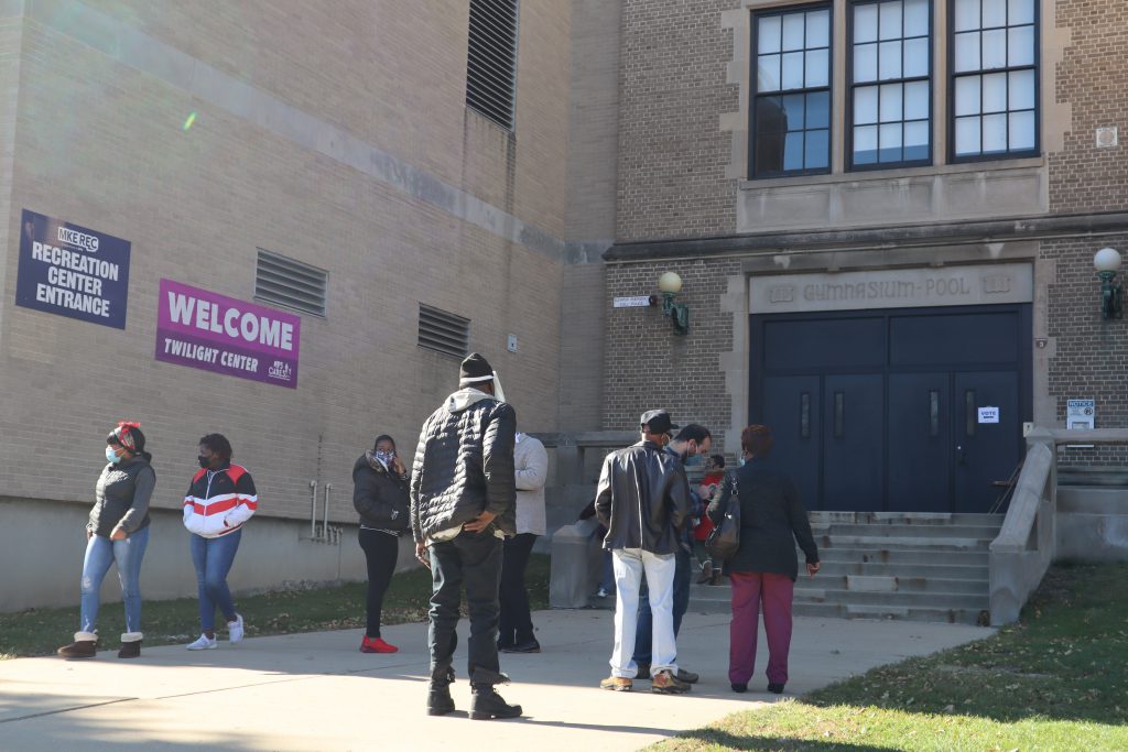 Voters wait outside Washington High School in Milwaukee to be led in to vote. Photo by Isiah Holmes/Wisconsin Examiner.