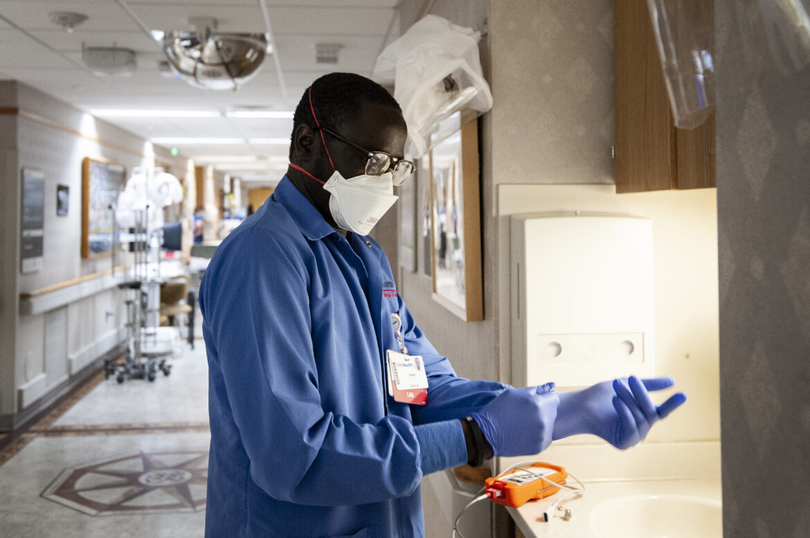 Phlebotomist Essaha Ceesay works in a COVID-19 unit on Nov. 17, 2020, at UW Health’s University Hospital in Madison, Wis. Angela Major / WPR