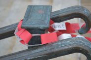 Every ring in the chain represents someone who has died from COVID-19 in Wisconsin. The rings are inscribed with the names of the counties where people have died. Photo by Erik Gunn/Wisconsin Examiner.