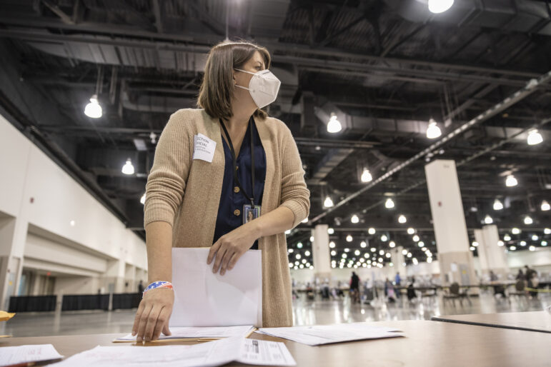 Claire Woodall-Vogg, executive director of the Milwaukee Election Commission, works at the presidential recount at the Wisconsin Center convention center in Milwaukee on Nov. 25, 2020. Woodall-Vogg says that when faced with the monumental task of running an election, “When there’s no one else to do it, you just … do it.” Sara Stathas for Wisconsin Watch