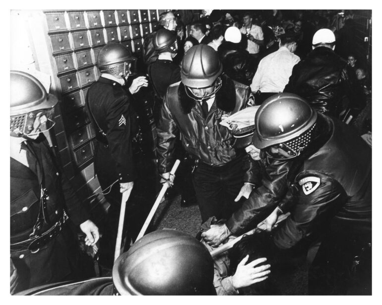 University of Wisconsin-Madison students clash with riot police during a campus demonstration against Dow Chemical’s involvement in the Vietnam War. Here, several club-wielding police officers hold a student down on the floor. Wisconsin Historical Society, Image 2289
