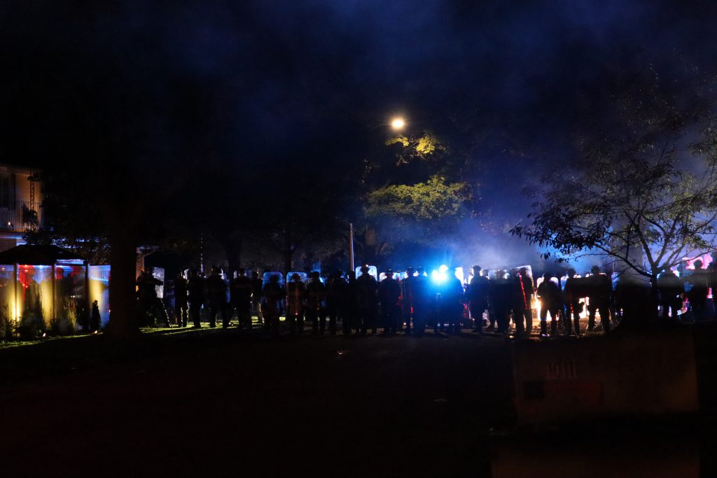 Police block a road during the October Wauwatosa curfew, after having just shot rubber bullets and tear gas at protesters and their cars. Photo by Isiah Holmes/Wisconsin Examiner.