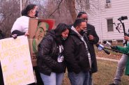 The family of Joel Acevedo stand in from of Michael Mattioli's former home shortly before Christmas eve, 2020. Photo by Isiah Holmes/Wisconsin Examiner.