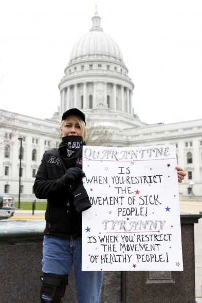 Theresa Zanon, of Mukwonago, Wis., is seen at a protest of Gov. Tony Evers’ Safer at Home order at the Wisconsin State Capitol on April 24, 2020. Zanon owns a bar and grill that was shuttered under the order to curb the spread of COVID-19; the Wisconsin Supreme Court overturned the order weeks later. At the time, Zanon accused the government of misrepresenting the number of people who have tested positive for the virus, citing research she did on the internet. Brad Horn / Wisconsin Watch