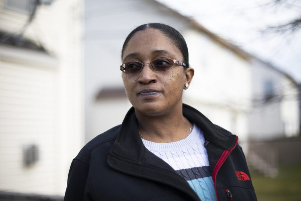 Like many patients in similar circumstances, Maneisha Gaston was confused to learn that Froedtert Hospital filed liens against her and her son to recover the cost of treating their car crash injuries. She initially worried the liens applied to the home she proudly purchased three years ago on Milwaukee’s North Side. Instead, the legal filing would reduce compensation she might receive from a crash-related lawsuit — if one is filed. Gaston is seen here outside her home on Dec. 21, 2020. Coburn Dukehart / Wisconsin Watch