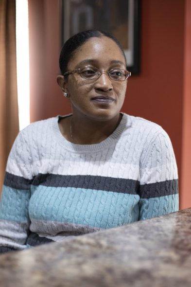 Maneisha Gaston is seen inside the kitchen of her Milwaukee home on Dec. 21, 2020. She fits the typical profile of people facing hospital liens, experts say: uninsured patients who were treated for car crash injuries. Crashes typically generate a police report with the names of the people involved, their insurance companies and other useful information. Those cases are also more likely to yield a settlement or judgment from which a hospital would be paid. Coburn Dukehart / Wisconsin Watch