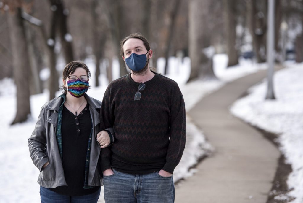 Andrew Seiner, right, stands with his wife, Morganne Seiner, left, on Jan. 9, 2021, at Firemen’s Park in Waterloo, Wis. Morgan received a COVID-19 diagnosis on New Year’s Day, prompting the couple to improvise ways to limit Andrew’s exposure while inside of their home. Angela Major / WPR