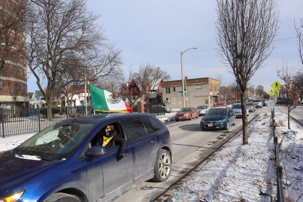 A car caravan makes its way across the Milwaukee south side as part of a national call to action for immigration reform. Photo Isiah Holmes/Wisconsin Examiner.