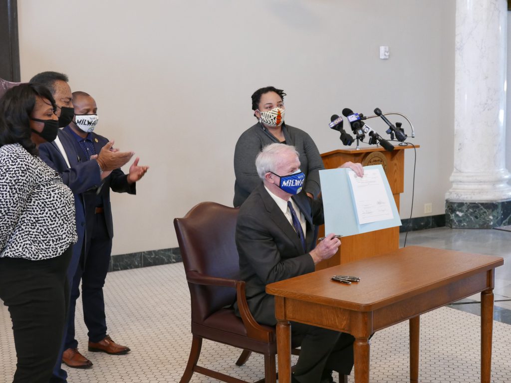 Mayor Barrett signs resolution officially renaming Old World Third St. to Martin Luther King Jr. Dr. Photo by Graham Kilmer.