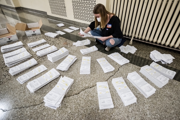 Madelyn Preston, a first-time poll worker, sorts absentee envelopes Tuesday, Nov. 3, 2020, in Madison. Angela Major/WPR