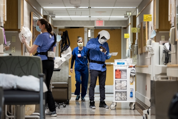 Healthcare workers pass through the hallway of a COVID-19 unit Tuesday, Nov. 17, 2020, at UW Hospital. Angela Major/WPR