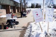 La Follette High School teachers teach their students virtually outside the school building to protest a lack of COVID-19 vaccines for teachers Thursday, March 4, 2021, in Madison, Wis. Angela Major/WPR