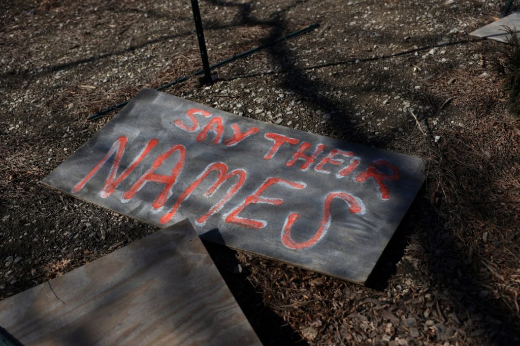 A sign reading “Say Their Names” lies on the ground in Victory Over Violence park on North Martin Luther King Jr. Drive in Milwaukee. That’s near where Jared Cain filmed and livestreamed protests and property damage just after midnight on June 1, 2020 — days after the police murder of George Floyd in Minneapolis. Credit: Coburn Dukehart / Wisconsin Watch