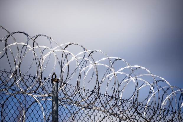 Sunlight reflects off of barbed wire that sits atop the fencing surrounding Lincoln Hills youth prison Thursday, April 15, 2021, in Irma, Wis. Angela Major/WPR