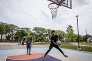 Milwaukee resident Myles Horton, right, plays basketball on a court at Columbia Playfield on Tuesday, May 25, 2021, in Milwaukee, Wis. Horton grew up playing at this park before it was renovated. Angela Major/WPR