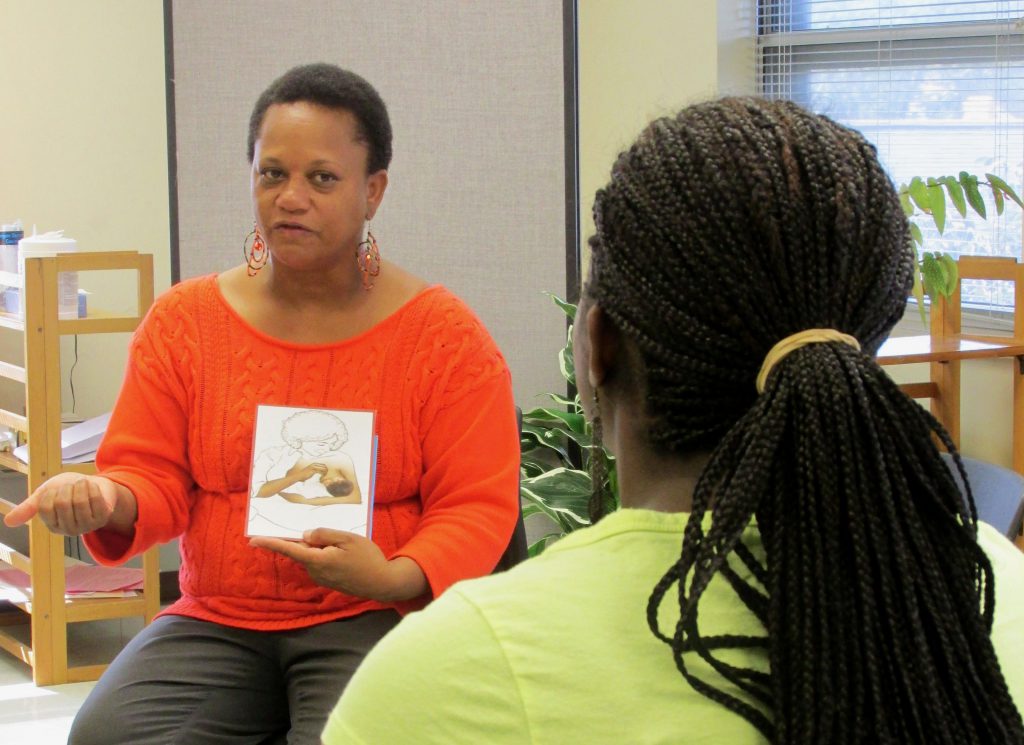 Dalvery Blackwell, founder of the Milwaukee-based African American Breastfeeding Network, says peer counseling programs allow counselors an opportunity to not “put women in a box and define who and what they are.” She’s shown providing maternity advice at the now-closed Marquette Neighborhood Health Center in 2013. NNS file photo by Kara Cucchiarelli.