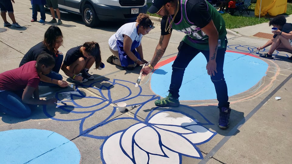 Youths and adults paint murals along several North Avenue crosswalks Saturday as part of a project to raise awareness about reckless driving in the community. Photo by Edgar Mendez/NNS.